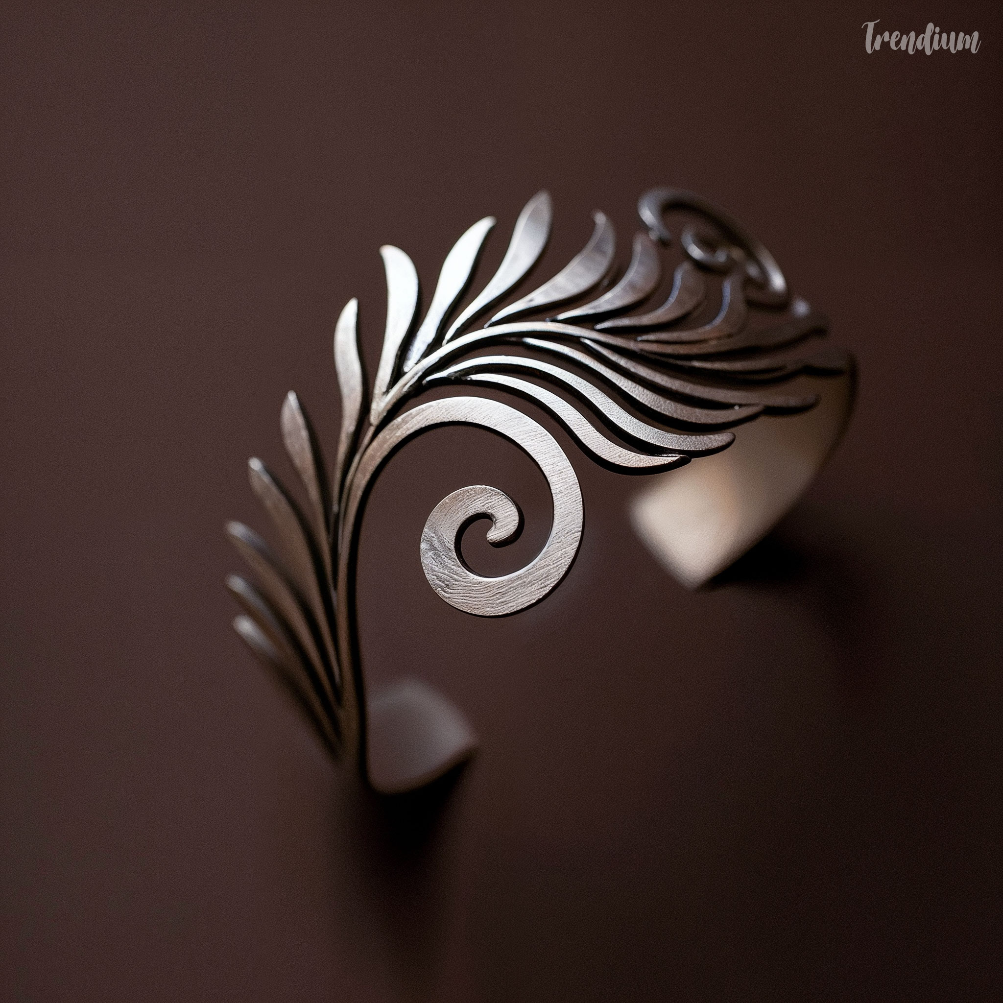 [prompt] fern inspired bracelet, spiral curling form, smooth organic lines, matte metal finish, modern botanical jewelry, minimal background, high detail --v 8.1