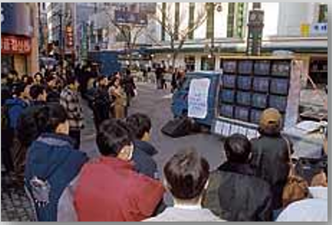 ▲ 노동자 총파업 승리를 위한 공동영상제작단(1997)이 집회 현장에 마련한 '명동 민주방송국' 화면을 유심히 지켜보는 사람들 (사진 출처: 한겨레21)