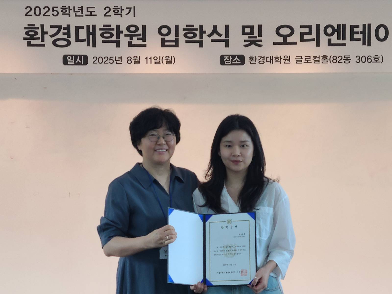 윤순진 원장님이 우수 학생에게 장학증서를 수여하는 모습