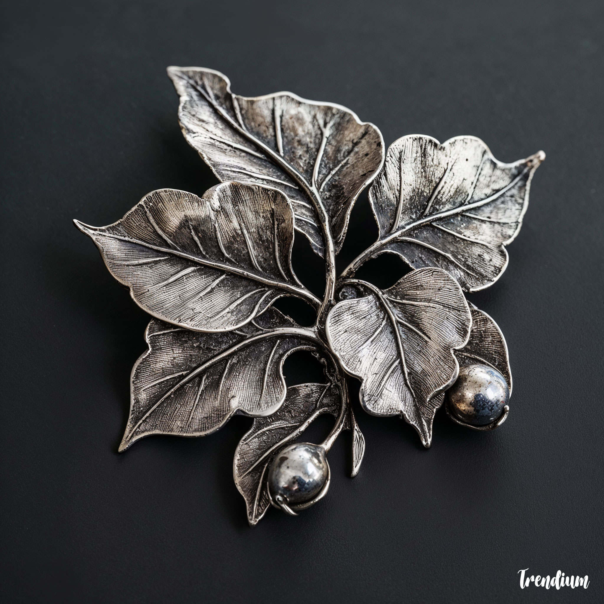 [prompt] A hand-crafted silver brooch in the style of Charles Robert Ashbee, featuring natural leaf motifs, asymmetrical form, Arts and Crafts style, artisan texture, vintage lighting